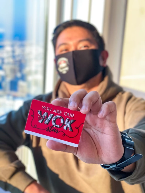 Customer holding Asian Wok gift card