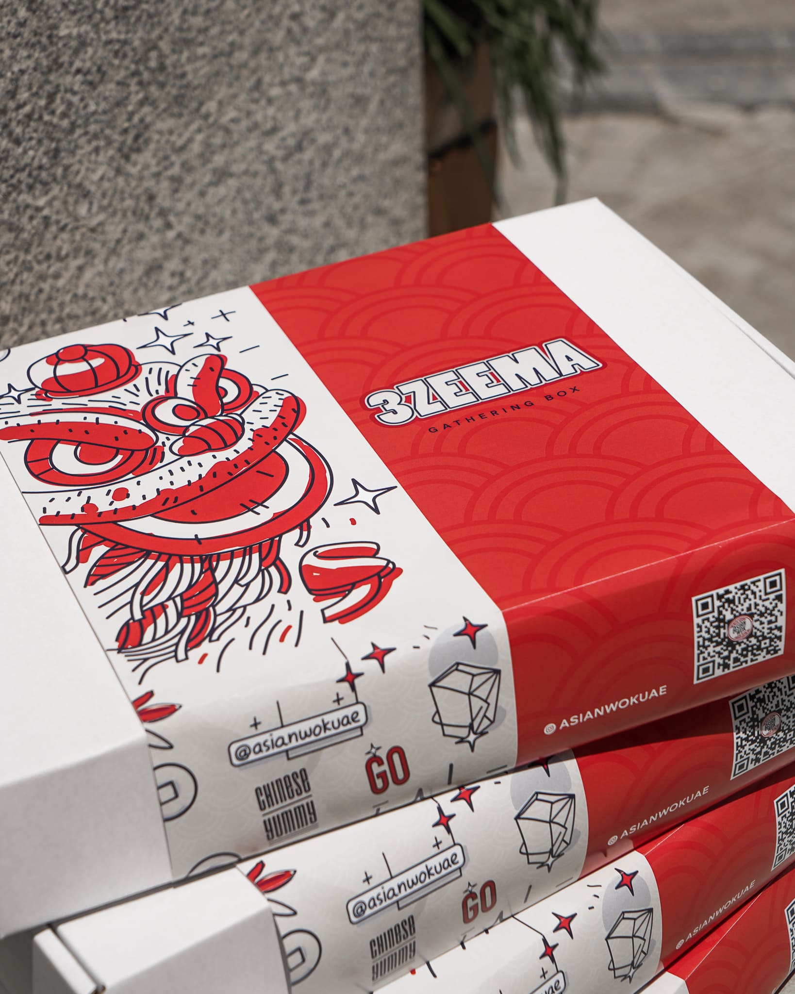 Stacked Asian Wok 3zeema gathering boxes with printed sleeves