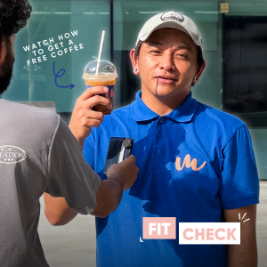 barista holding a coffee drink in his hands before the launch