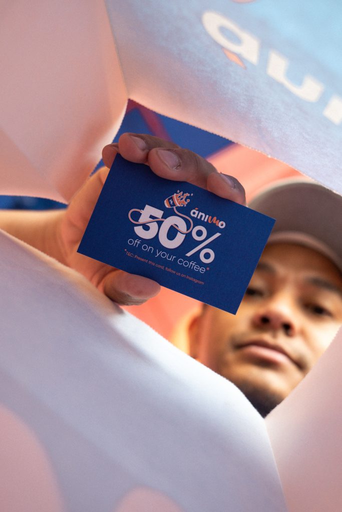 man looking into a packet and holding a card for a coffee shop launch in dubai
