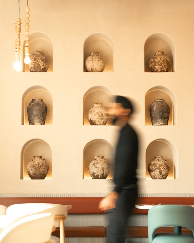 Authentic Pakistani restaurant decor supporting repositioning strategy at Nayaab Haandi with traditional wall plates and premium atmosphere.