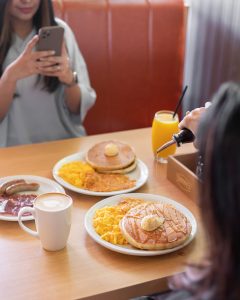 dennys restuarant marketing team taking a picture of the endless breakfast campaign