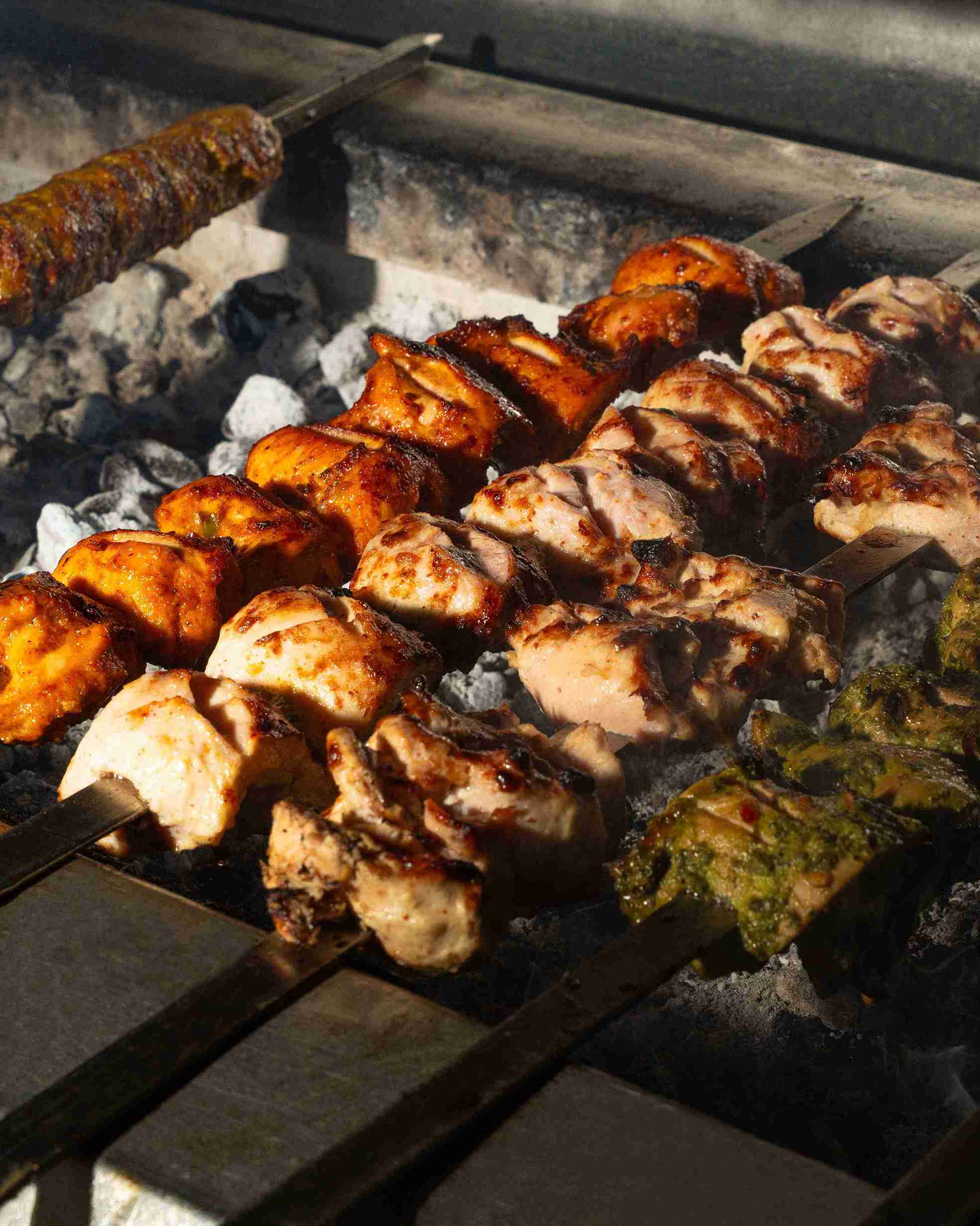 Nayaab Haandi kebabs grilling over charcoal
