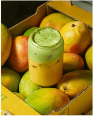 Mitts & Trays green matcha mango drink in a box of mangoes