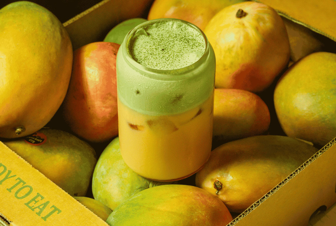 Mitts & Trays matcha mango drink in a box of mangoes